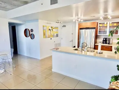 a kitchen with a sink and a counter top at Classy 2BD 2BTH at Midblock with FREE PARKING in Miami