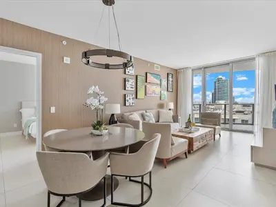 a living room with a table and chairs at Beachside Contemporary Residence in Lyfe in Hollywood