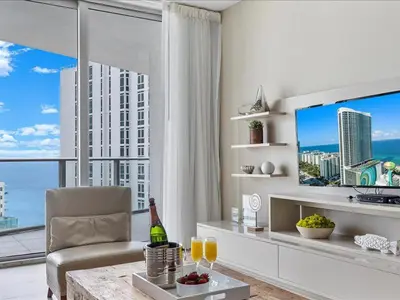 a living room with a large window and a television at Beachside Contemporary Residence in Lyfe in Hollywood