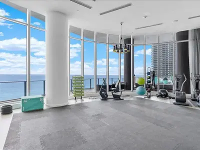 a gym with a view of the ocean in a building at Beachside Contemporary Residence in Lyfe in Hollywood