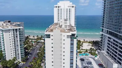 an aerial view of two tall buildings next to the beach at YP PROPERTY MANAGEMENT in Hollywood