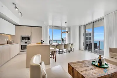 a kitchen and living room with a view of the ocean at Insane Ocean View Balcony- Beachfront Resort - Pools in Hollywood