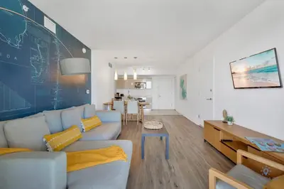 a living room with a couch and a chalkboard wall at Spectacular Balcony plus Near Beach, Gym, Pool in Hallandale Beach