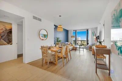 a dining room with a table and chairs at Infinite Views with Amazing Pool plus Gym, Near Beach in Hallandale Beach