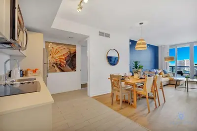 a kitchen and dining room with a table and chairs at Infinite Views, Amazing Pool, Gym, Near Beach in Hallandale Beach