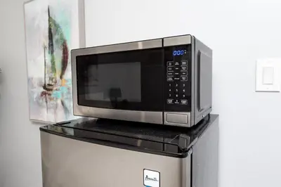 a microwave sitting on top of a refrigerator at Shell on the Beach 105 - RENOVATED in Hollywood