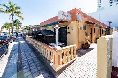 a building with a restaurant on a street at Shell on the Beach 103 - RENOVATED in Hollywood