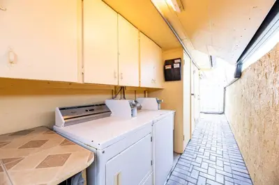 a small kitchen with a stove and a dishwasher at Shell on the Beach 103 - RENOVATED in Hollywood