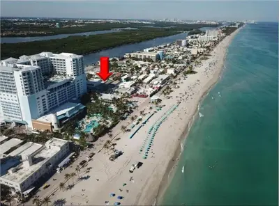 an aerial view of a beach with a red arrow at Shell on the Beach 101 in Hollywood