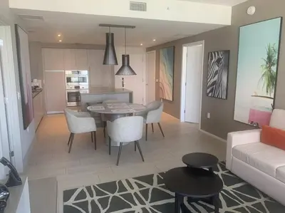 a kitchen and living room with a table and chairs at Luxury apartment- Hyde House Resort in Hollywood