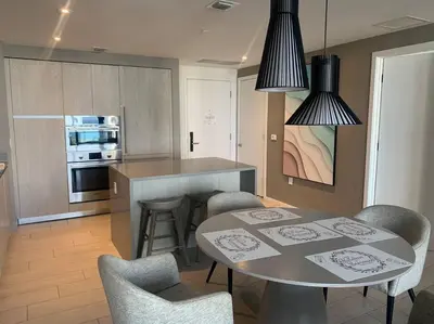 a kitchen with a table and chairs in a kitchen at Luxury apartment- Hyde House Resort in Hollywood