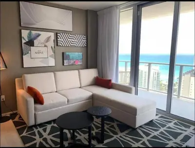 a living room with a white couch and a large window at Luxury apartment- Hyde House Resort in Hollywood