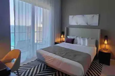 a bedroom with a large bed and a large window at Luxury apartment- Hyde House Resort in Hollywood