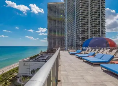 a view of the beach from the balcony of a building at Ocean View Balcony, Beachfront Resort, Amazing Pool in Hollywood