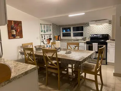 a kitchen with a dining room table and chairs at Private Rooms in Miami