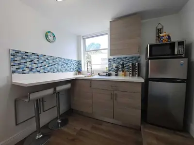 a kitchen with a sink and a refrigerator at Relax 521- at the side in Miami