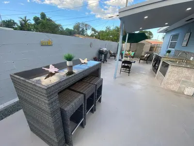 a patio with a table and chairs and a grill at Relax 521 in Miami