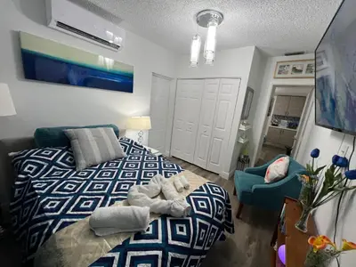 a bedroom with a bed and a couch and a chair at Relax 521 in Miami