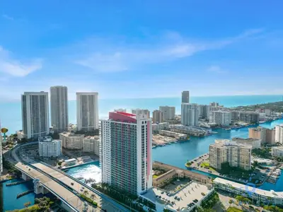 an aerial view of a city with a river and buildings at Infinite View and Balcony with Pool, Gym, Near Beach in Hallandale Beach