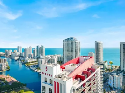 an aerial view of a city with the ocean at Upper studio with Balcony,Pool and Gym, Near Beach in Hallandale Beach