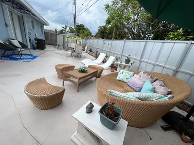 a patio with wicker chairs and a couch and tables at Relax 523 in Miami