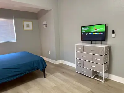 a bedroom with a bed and a television on a dresser at Modern cozy home with private patio - Sleeps 6 in Miami