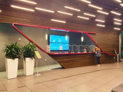 a woman standing at a bar in an airport at Cozy BeachWalk Nest 2 Full Beds, Steps to Ocean -2010B in Hallandale Beach
