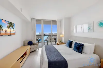 a bedroom with a bed and a view of the ocean at Spacious 2BR Condo, Sleeps 6, Beachwalk Resort in Hallandale Beach