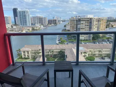 a balcony with chairs and a view of a river at Premium Oceanview Living Full Kitchen & Miami Chic Vibes -14 A in Hallandale Beach