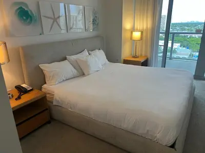a bedroom with a large bed with white sheets and pillows at Premium Oceanview Living Full Kitchen & Miami Chic Vibes -14 A in Hallandale Beach