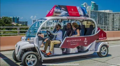 a group of people riding in a golf cart at Premium Oceanview Living Full Kitchen & Miami Chic Vibes -14 A in Hallandale Beach