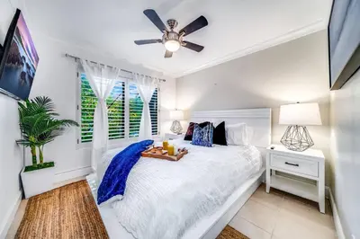 a bedroom with a bed with a tray of food on it at Pool and Waterfront Oasis in Fort Lauderdale