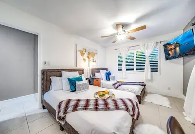 a bedroom with two beds and a ceiling fan at Pool and Waterfront Oasis in Fort Lauderdale