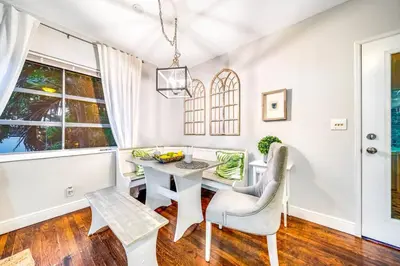 a white dining room with a table and chairs at Pool and Beach Relaxing Close to Everything in Dania Beach