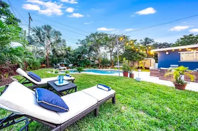 a backyard with two couches and a pool at Pool and Beach Relaxing Close to Everything in Dania Beach