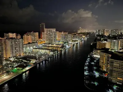 a view of a city at night with a river at Sunlit BeachWalk Studio 2 Full Beds Coastal Charm -26B in Hallandale Beach