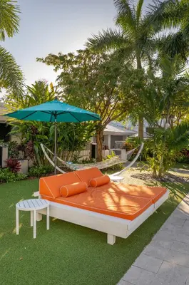a large bed with an umbrella and a chair at The Vagabond Hotel Miami in Miami