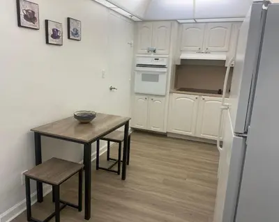 a small kitchen with a table and a refrigerator at The Tides! On the beach, Sea view! in Hollywood