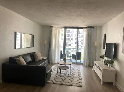 a living room with a couch and a table at The Tides! On the beach, Sea view! in Hollywood