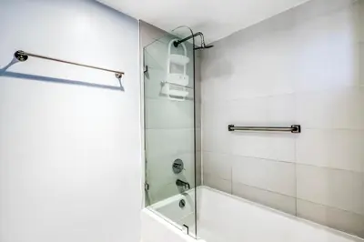 a bathroom with a shower with a glass door at Stunning Penthouse Suite Waterfront 2BD 2BA in Hallandale Beach