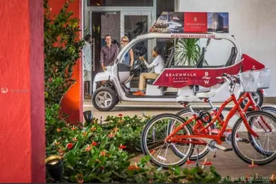 a small car with bikes parked in front of it at Stunning Penthouse Suite Waterfront 2BD 2BA in Hallandale Beach