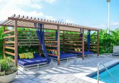 a wooden pergola next to a swimming pool at Amazing Condo with Pool at Midblock Miami in Miami