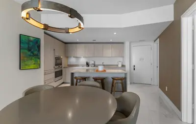 a kitchen with a large white table and chairs at Lyfe Oceanview Resort Luxury 2 Bedroom Unit in Hollywood