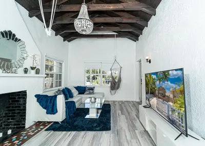 a living room with a couch and a fireplace at Bike to Beach-Spacious With Patio BBQ & Game Room (Pet-Friendly) in Hallandale Beach