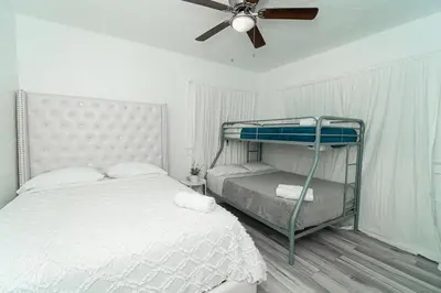 a bedroom with a bunk bed and a ceiling fan at Bike to Beach-Spacious With Patio BBQ & Game Room (Pet-Friendly) in Hallandale Beach
