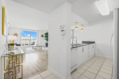 a white kitchen with a sink and a counter at High Floor Unit Located in Brickell - Free Parking in Miami