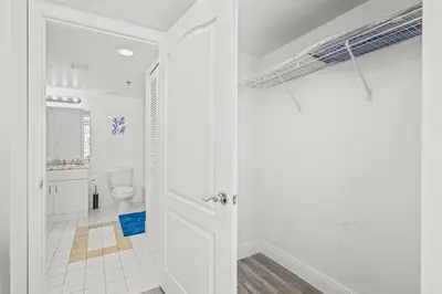 a white bathroom with a toilet and a shower at High Floor Unit Located in Brickell - Free Parking in Miami