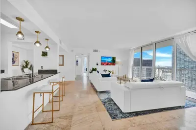 a living room with white furniture and large windows at 40th Floor Priceless Unit Central Location in Miami