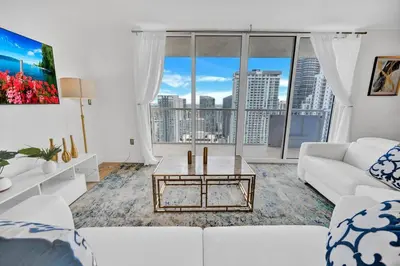 a living room with a white couch and a table at 40th Floor Priceless Unit Central Location in Miami