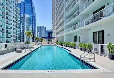 a swimming pool in the middle of a building at 40th Floor Priceless Unit Central Location in Miami